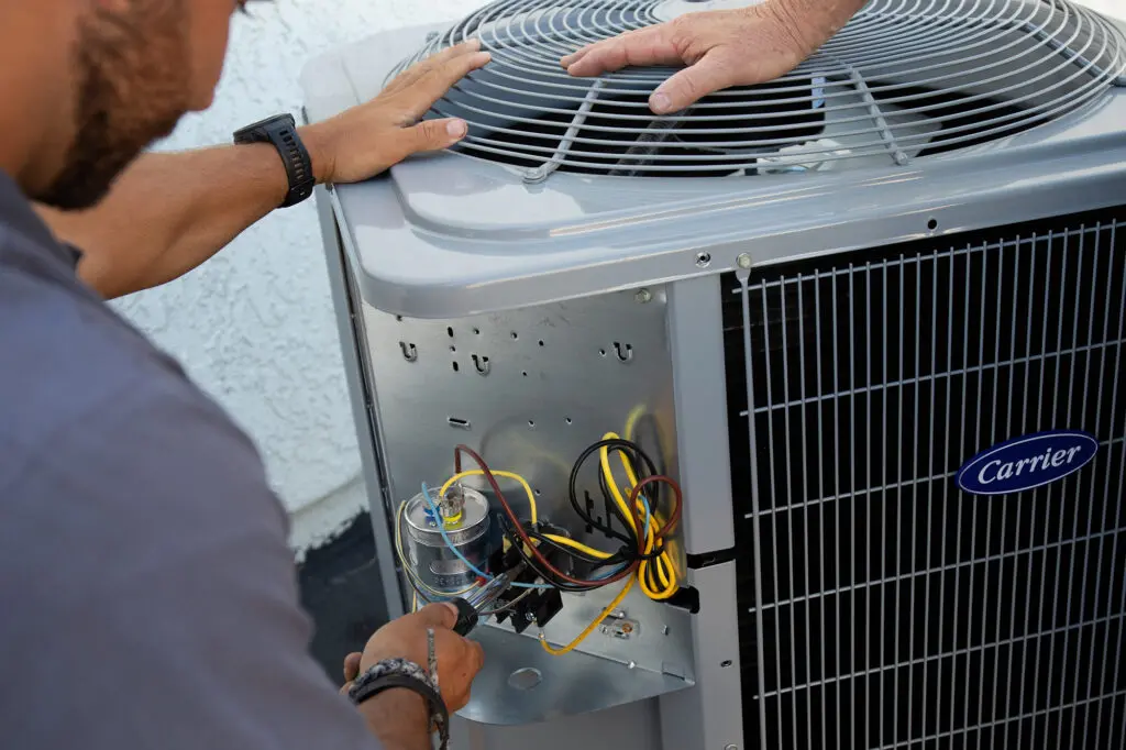 A/C Unit Repair with Man Working on It HVAC Repair
