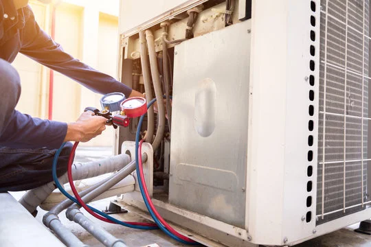 Man Fixing Wiring In Furnace HVAC Repair
