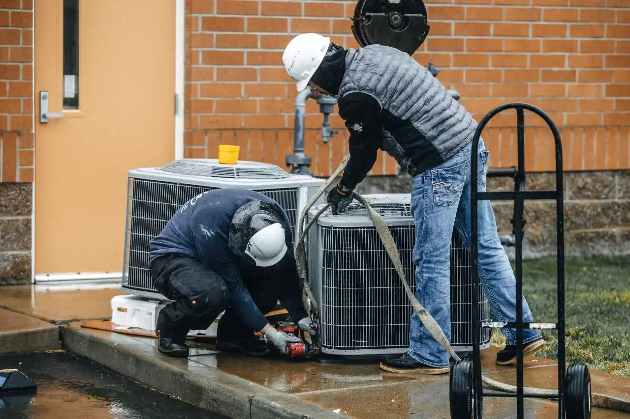 Two Men Doing Work and Maintenance on Units HVAC Repair and Maintenance