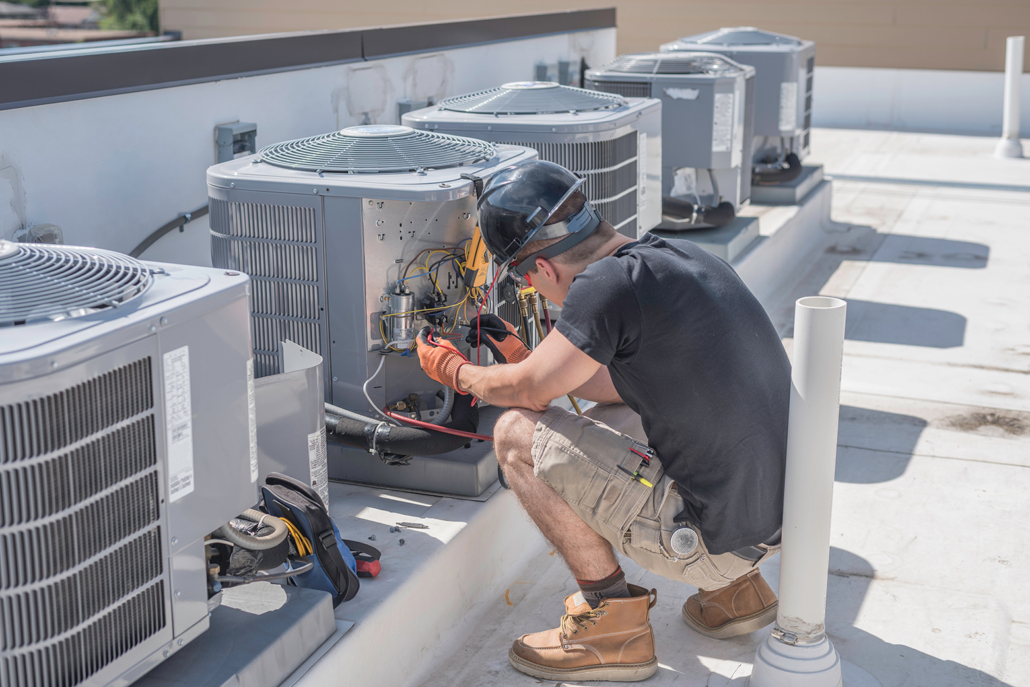 Man Servicing Units and Testing Units HVAC Repair and Maintenance